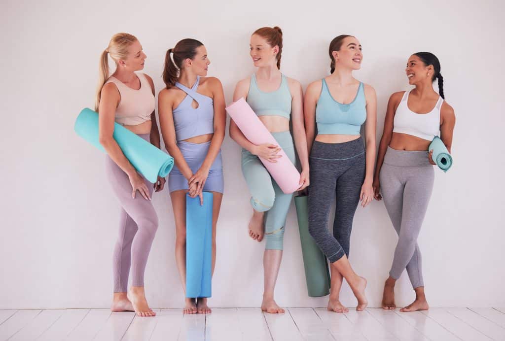 Women fitness group, pilates studio or together in class for discussion, training ideas or talking for motivation