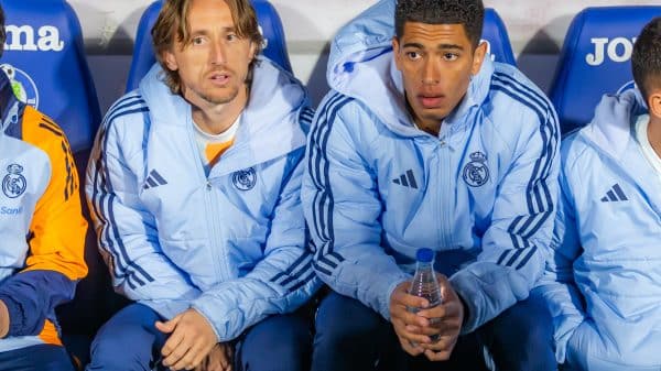 Luka Modric sits next to Jude Bellingham on the Real Madrid bench.