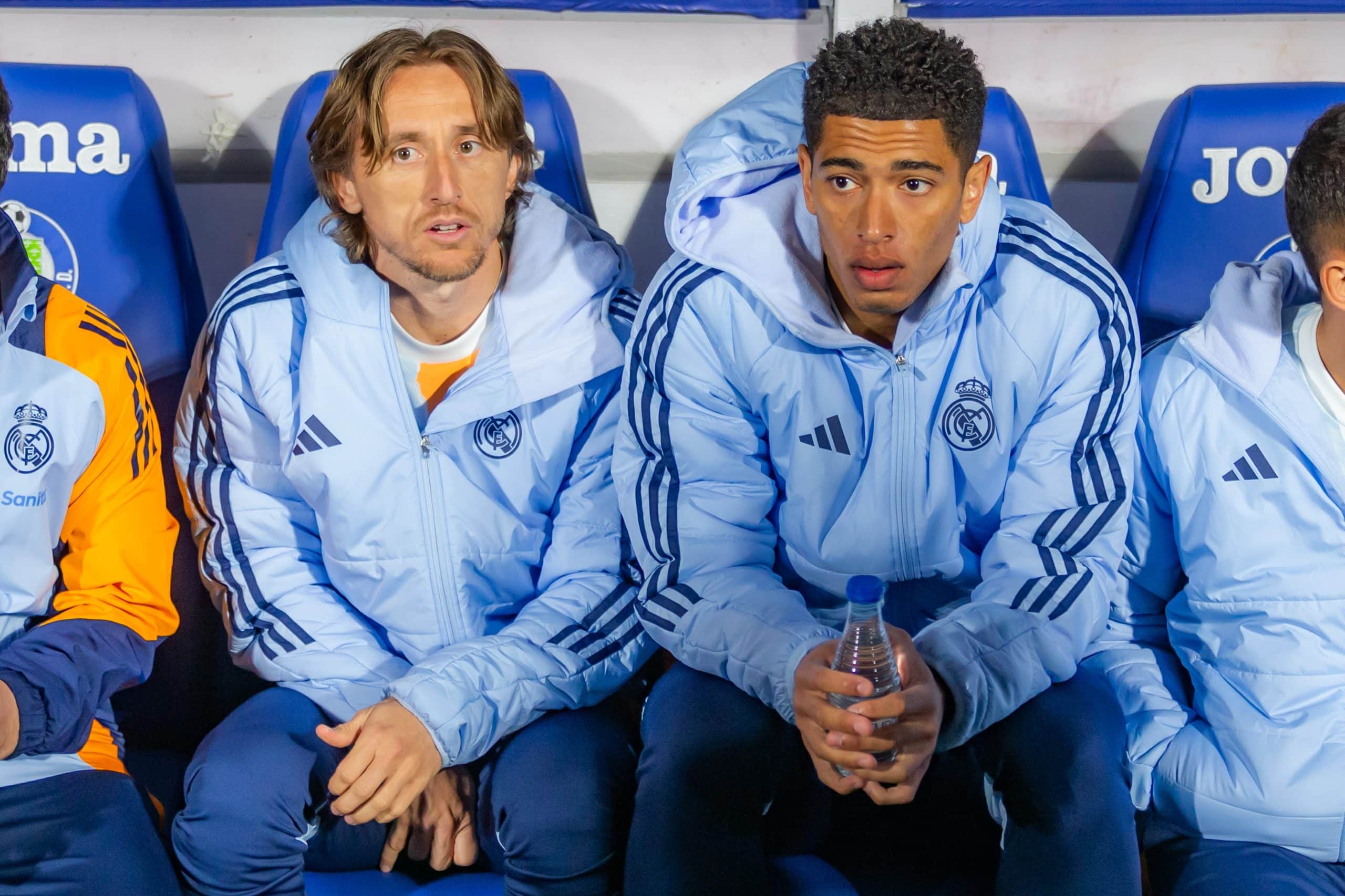 Luka Modric sits next to Jude Bellingham on the Real Madrid bench.
