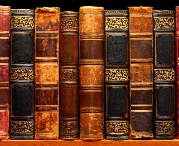 Old, classic books on a shelf.