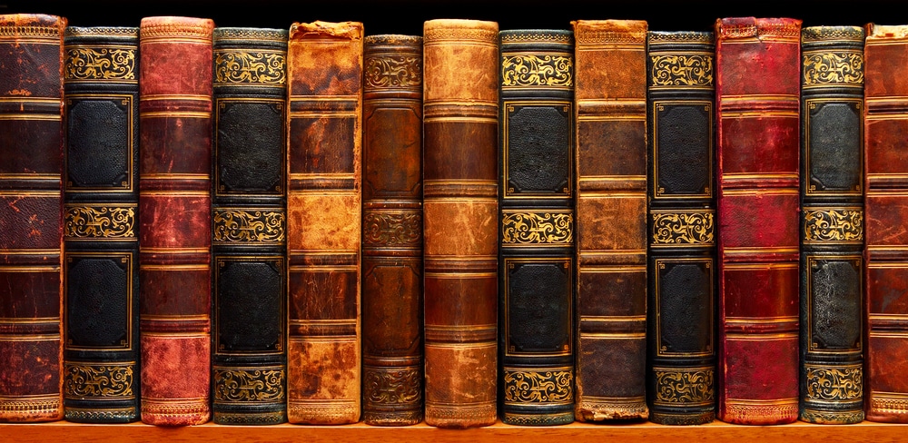 Old, classic books on a shelf.