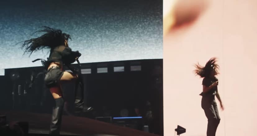Coachella stage, Lorde and Charli XCX jump around during their performance.