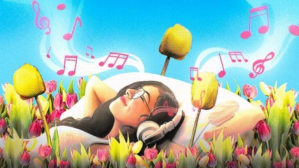 Woman laying in flowers listening to music