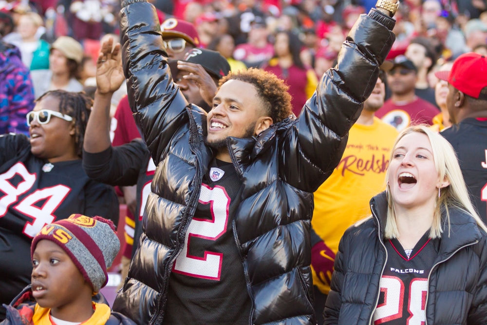 Falcons fans cheer for their team in the stands.