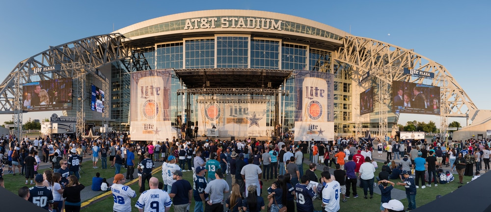 Fans gather and wait for a game to start outside of AT&T Stadium in Dallas.