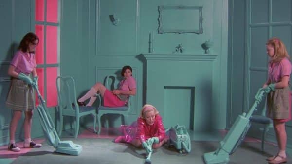 The girls are learning how to fulfill their gender role by cleaning.