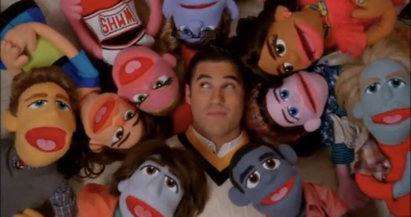 Blaine Anderson surrounded by puppets.