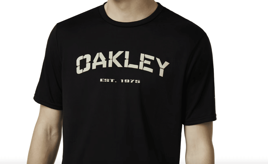 A black Oakley t-shirt on a model that reads: Oakley, Established 1975