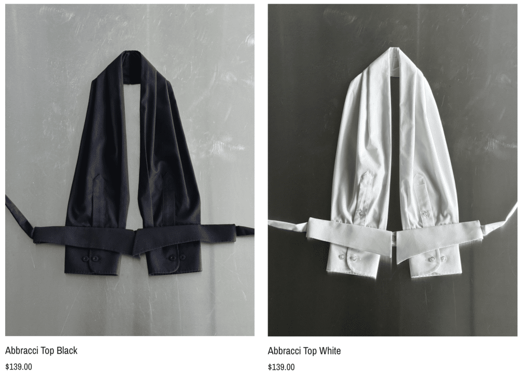 Two tops lay in front of a simple background. The same tops, one is black and one is white.