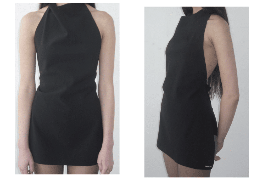 A woman is modeling a black, chic, backless halter top from Capsool's brand.