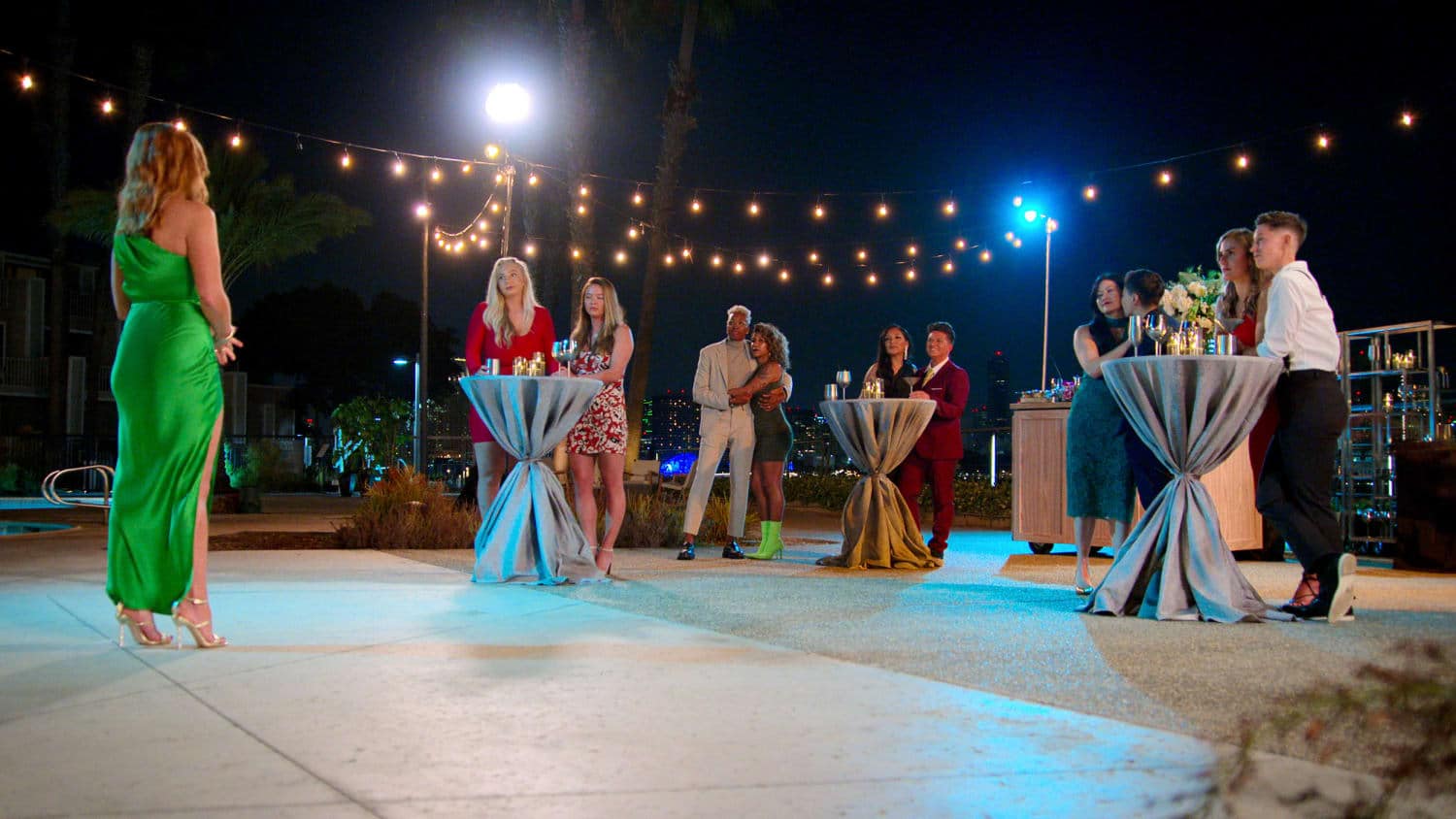 The cast of The Ultimatum: Queer Love gather together in front of host JoAnna Garcia Swisher.