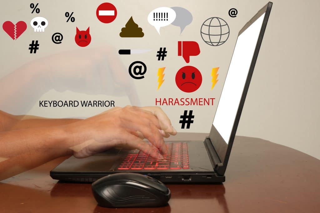 Online hate speech comes out of a computer screen.