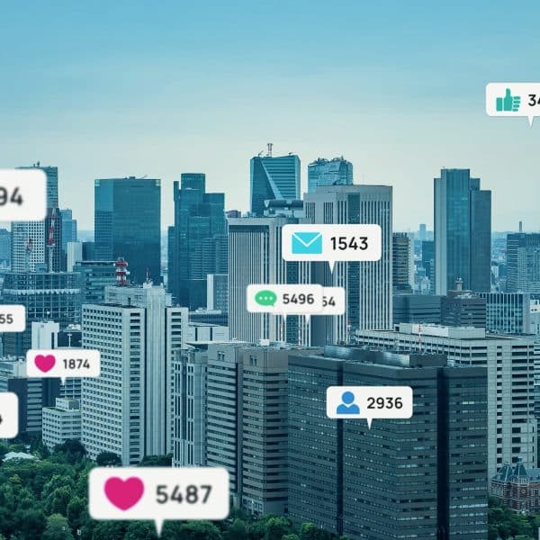 Hearts, likes, and comment bubbles float over a city skyline.