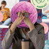 Someone with a yarn ball head contempleting between crocheting as just a hobby. With her expressions being more joyful as she works. And the other side shows the struggles of a side hustle with the women looking notabley stressed out.