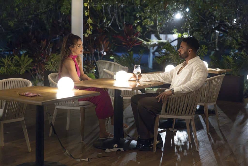 Susie and Justin talk at a table