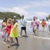 the Goldens walk onto the beach