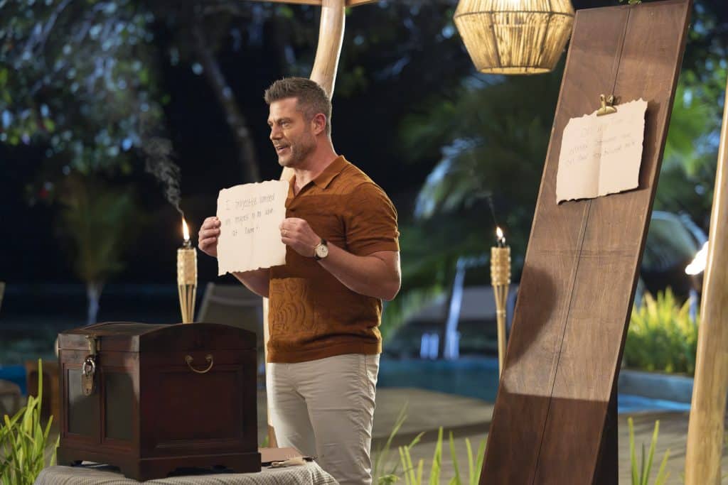 Jesse holds up a piece of paper with someone's secret written on it