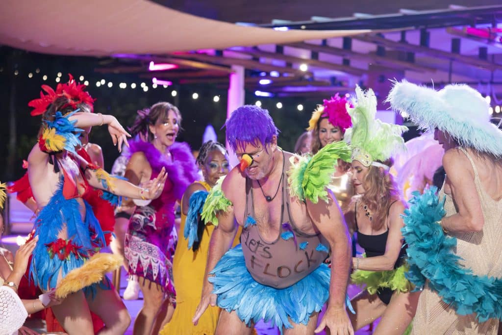 Cast dancing in bird costumes.