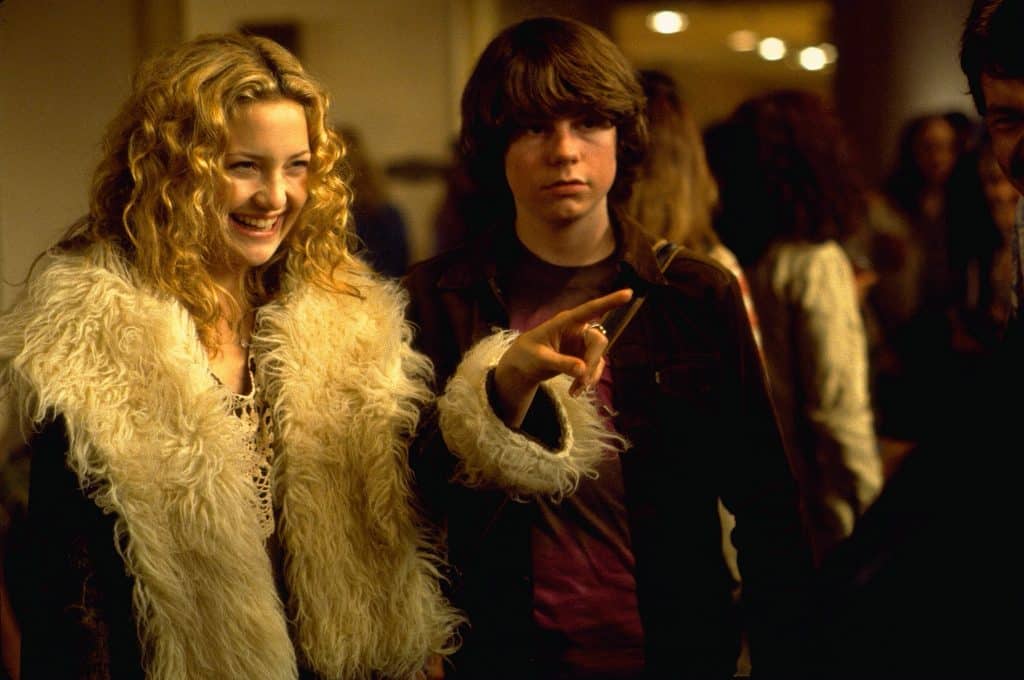 Penny lane points at something offscreen with William standing next to her.