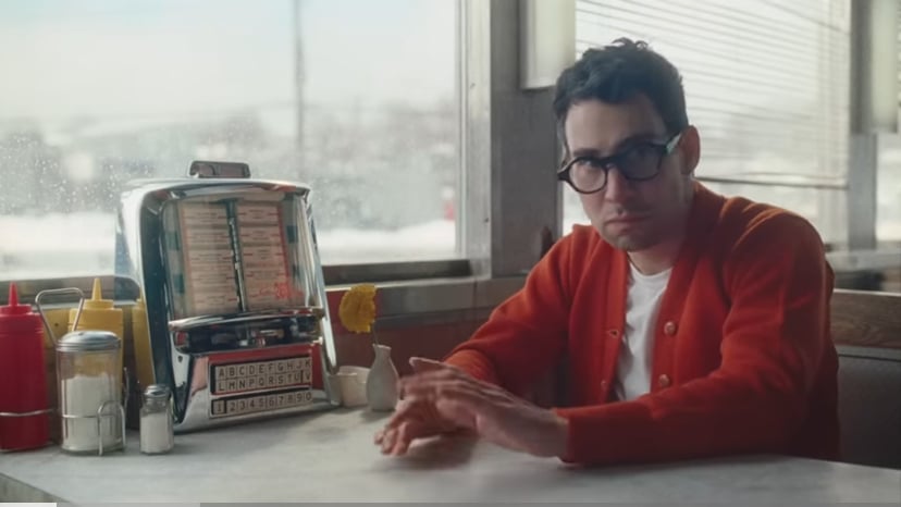 Jack Antonoff sitting alone at a diner booth.