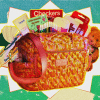 Image shows a blue, green. and ivory splattered background. In front of background is a woven basket with children's items peeking out from behind the basket.