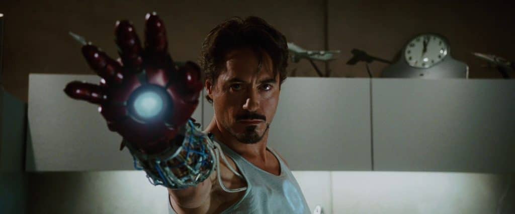 Tony Stark wielding the Iron Man glove, preparing to shoot it.