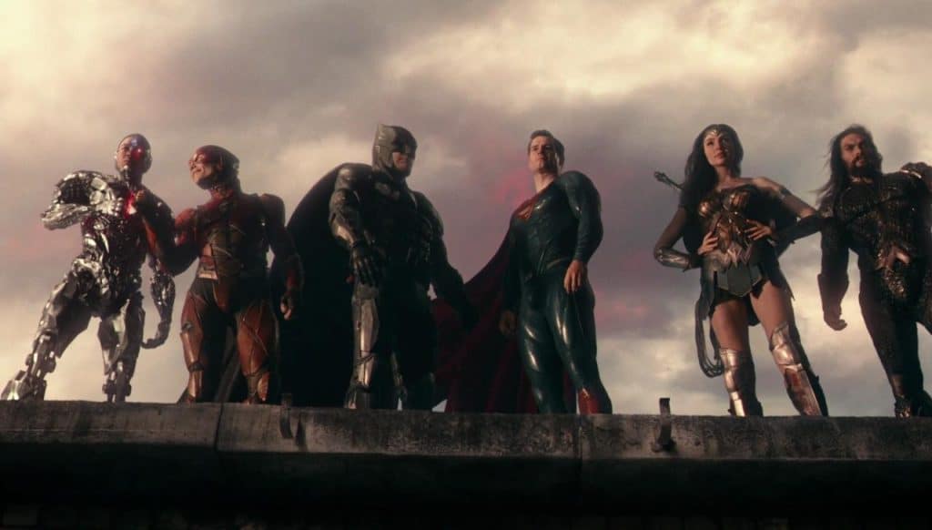The Justice League standing on a cliff.
