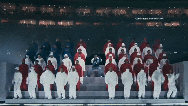 Kendrick Lamar performs in the center of dancers arranged to look like the American Flag