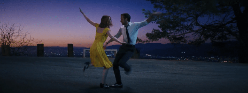 Man and woman dancing at sunset.