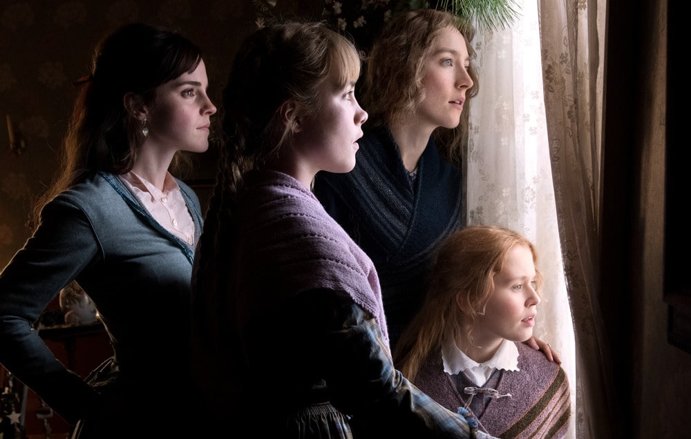 Four women gaze out of a window.