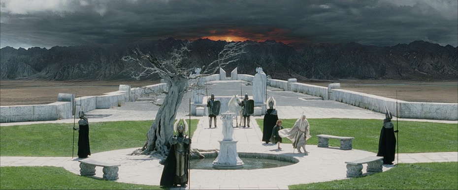 Scene from "The Return of the King," of Gandalf, Pippin, and Guards of Minas Tirith, within the fortress grounds, against a backdrop of Mordor.