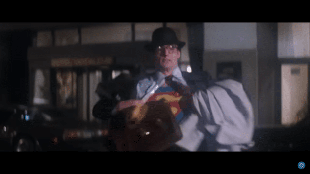 Superman (Christopher Reeve) revealing his supersuit under his clothes