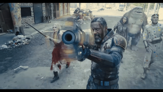 The Suicide Squad shooting several enemies off screen