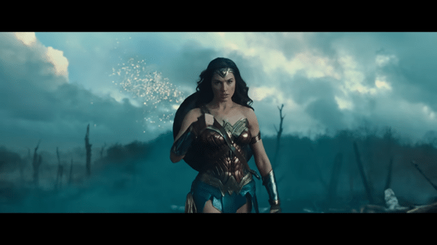Wonder Woman (Gal Gadot) standing in a battlefield.
