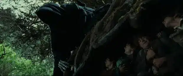 Frodo, Sam, Merry, and Pippin hide under the cover of tree roots in "The Fellowship of the Ring" during a close encounter with the Ringwraith hunting them.