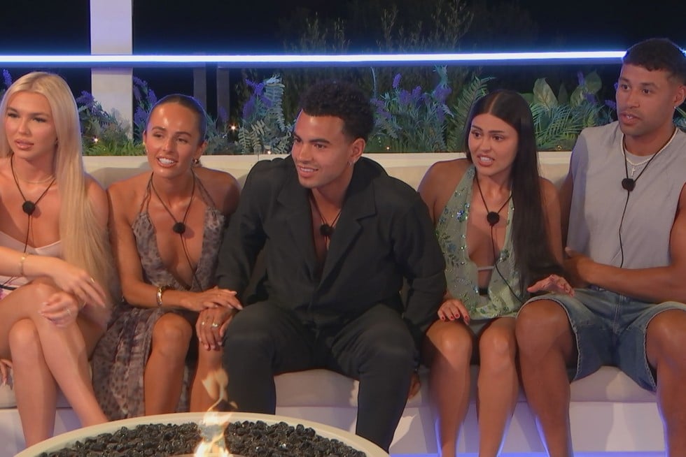Contestants of 'Love Island: UK' gather around the firepit.