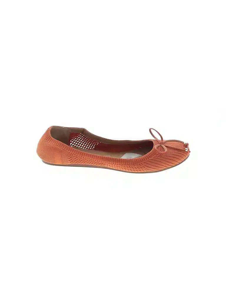 A ballet flat shoe in a orange color with a woven texture and a bow displayed on a white background.