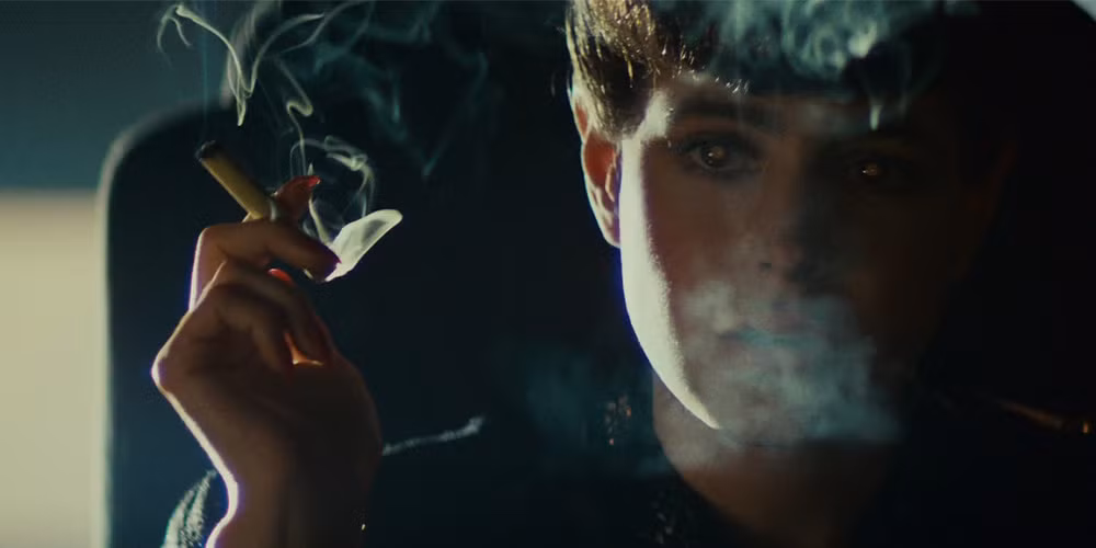 A replicant in Blade Runner smokes a cigarette