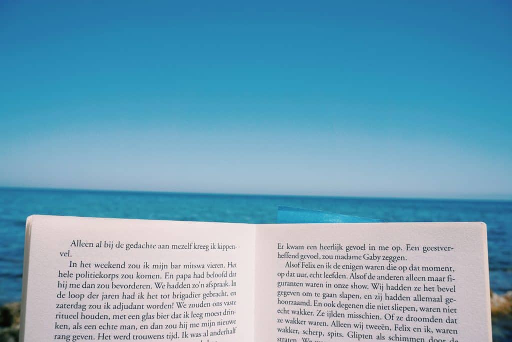 An open book in front of the sea.