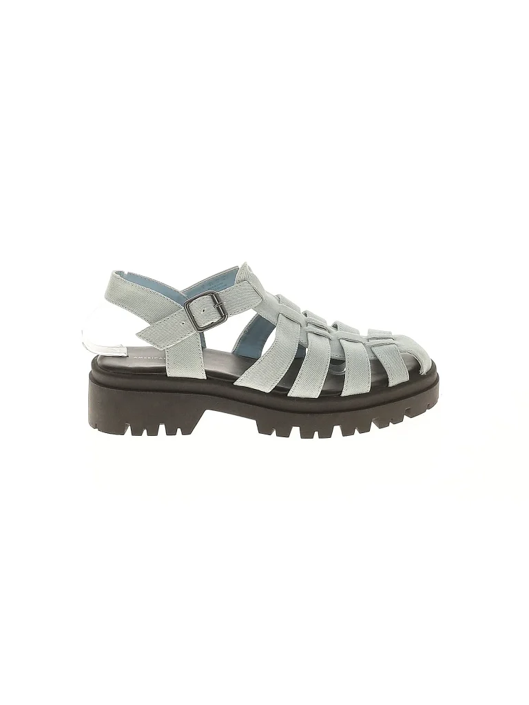 A fisherman sandal with white straps and a black sole on a white background.