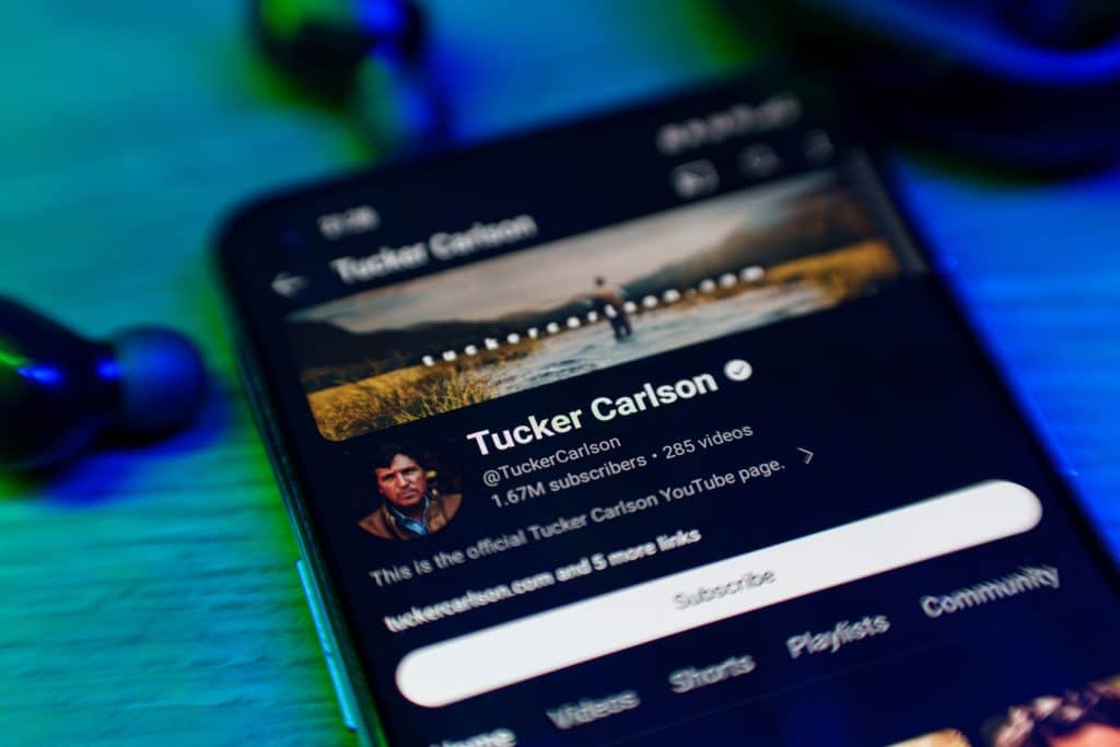Depicts the homepage of Tucker Carlson's YoutTube channel on a cell phone.