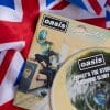 A photo of a flag of the United Kingdom with an Oasis CD of their second album (What's the Story) Morning Glory on top of the flag.