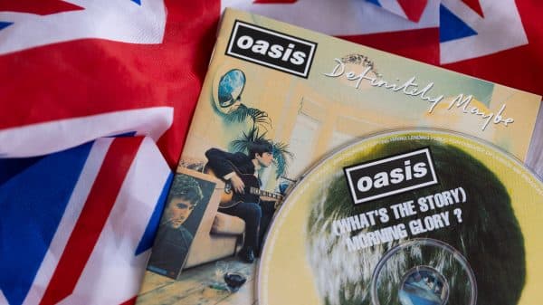 A photo of a flag of the United Kingdom with an Oasis CD of their second album (What's the Story) Morning Glory on top of the flag.