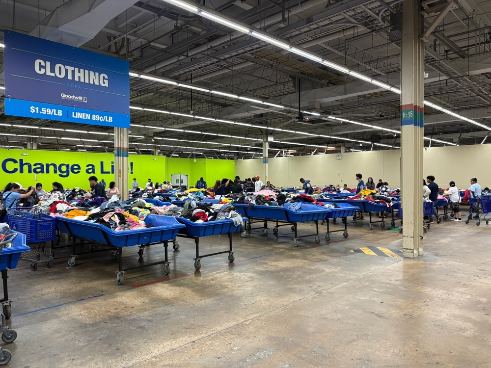 Rows of blue bins full of clothes span across the store.
