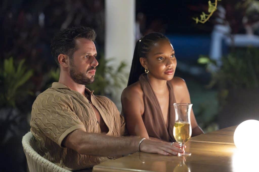 jeremy and bailey sit at a dinner table on the same side