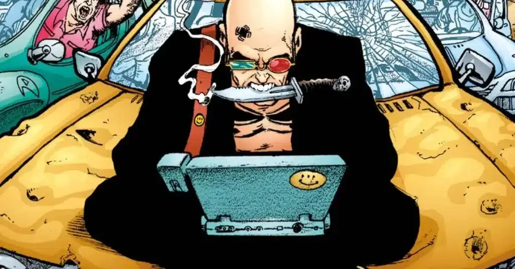 Spider Jerusalem (white, slim, bald man) typing nervously on his laptop while sitting atop the hood of a car, biting a knife with a cigarette stuck to its end.