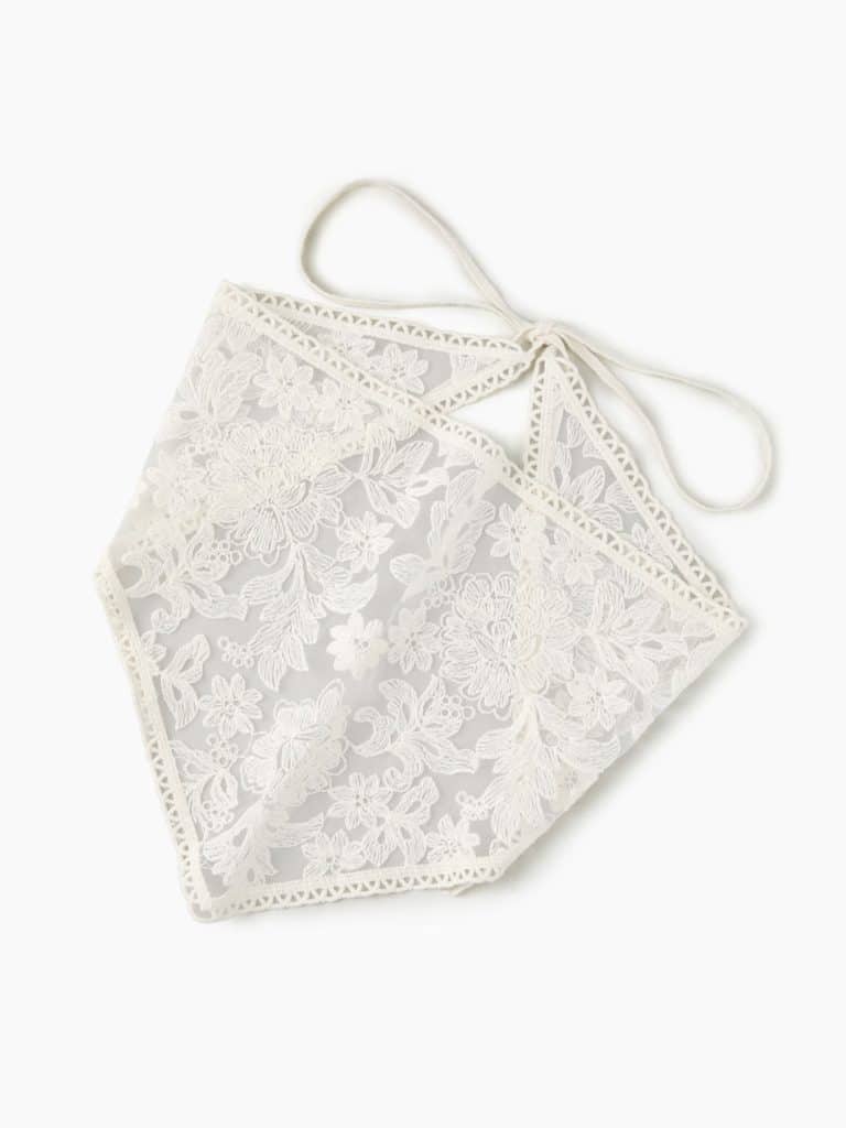 A white, floral, lace bandanna laid out on a white background. (Credit: Cider)