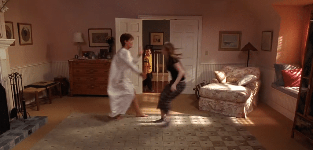 Anna and Tess sprinting towards each other as a boy enters a room.