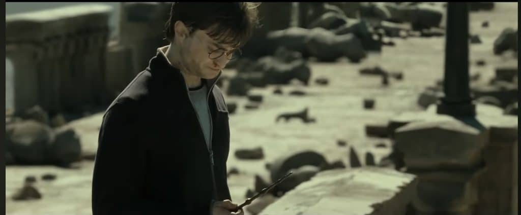 Harry Potter in Deathly Hallows Part 2 stands outside Hogwarts and destroys the Elder Wand.