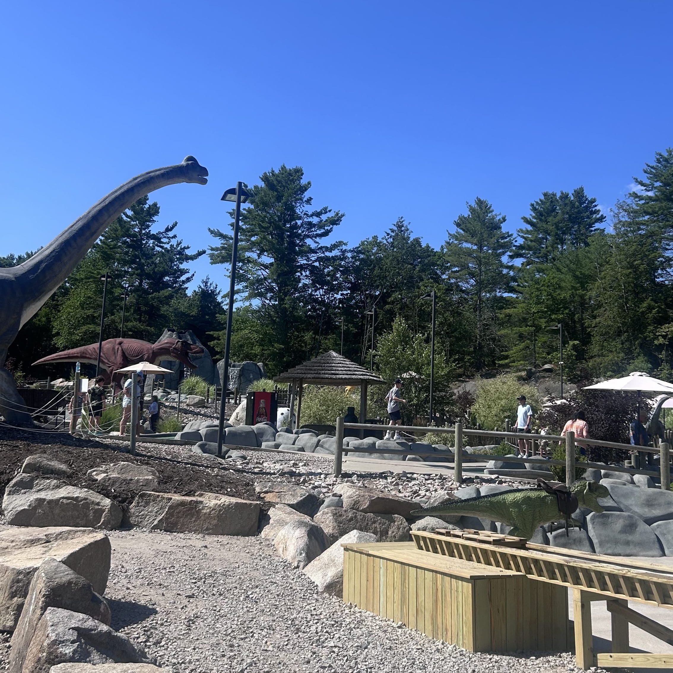 Views of the mini golf course and its animatronic dinosaurs at Raptor Falls.